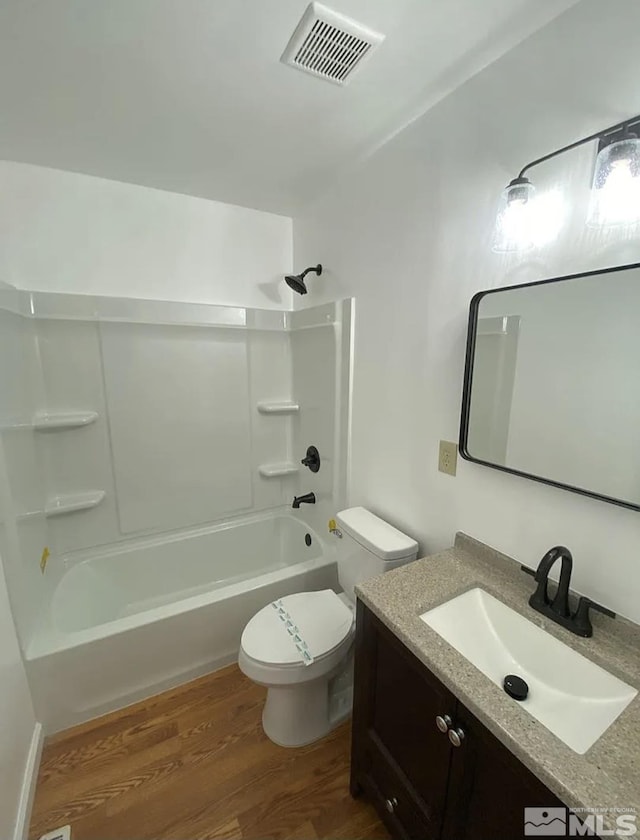 4621 Aster Dr, Reno, NV 89502 - full bath featuring toilet, vanity, wood finished floors, and shower / tub combination