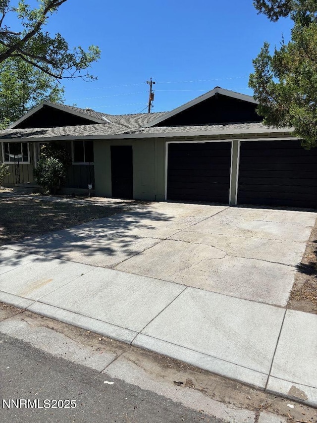 4621 Aster Dr, Reno, NV 89502 - view of front facade featuring an attached garage and concrete driveway