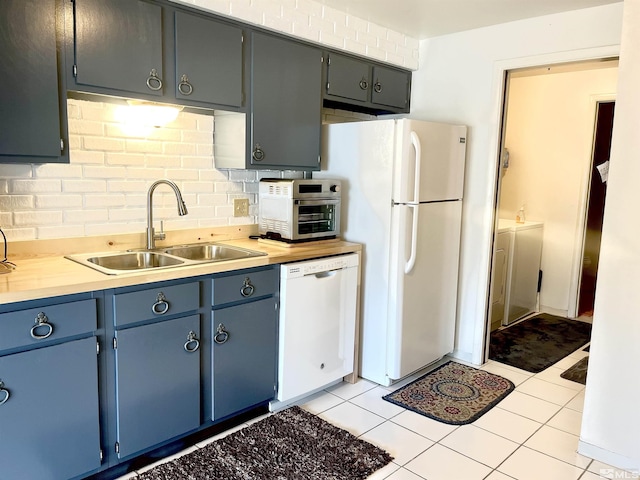2390 Oppio, Sparks, NV 89431 - kitchen with white appliances, backsplash, a sink, light countertops, and independent washer and dryer