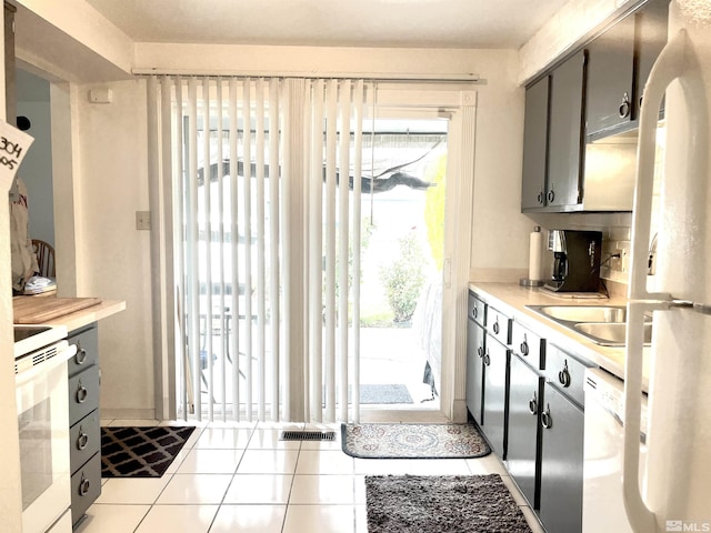 2390 Oppio, Sparks, NV 89431 - kitchen featuring white appliances, light countertops, tile patterned floors, and a sink