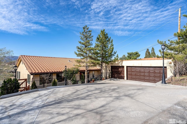 3075 Markridge Dr, Reno, NV 89509 - view of front of home with stucco siding, fence, concrete driveway, a garage, and a tiled roof