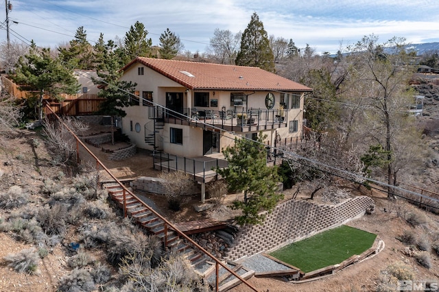 3075 Markridge Dr, Reno, NV 89509 - rear view of house featuring stairway, a tiled roof, stucco siding, and fence