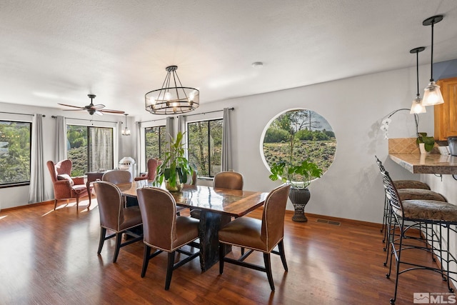 3075 Markridge Dr, Reno, NV 89509 - dining area with dark wood finished floors, a chandelier, baseboards, and ceiling fan