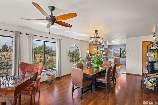 3075 Markridge Dr, Reno, NV 89509 - dining area with dark wood finished floors, ceiling fan, baseboards, and a chandelier