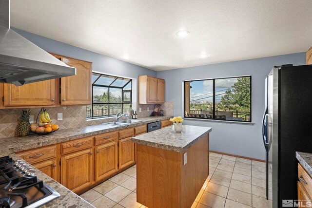 3075 Markridge Dr, Reno, NV 89509 - kitchen featuring stainless steel appliances, wall chimney range hood, a sink, tile counters, and backsplash