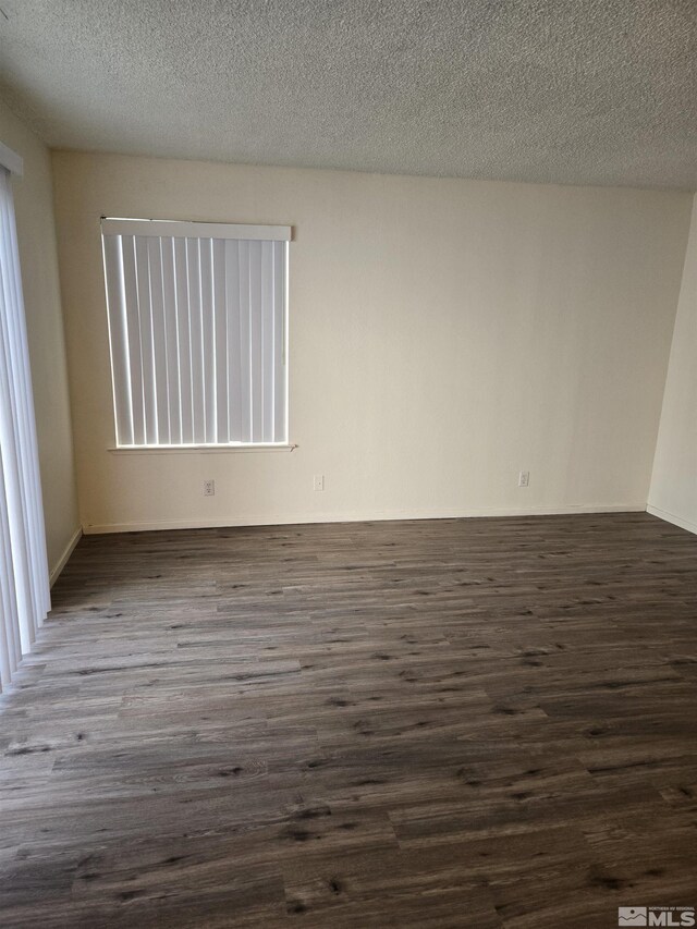 4604 Neil Rd Unit 157, Reno, NV 89502 - empty room with dark wood finished floors and a textured ceiling