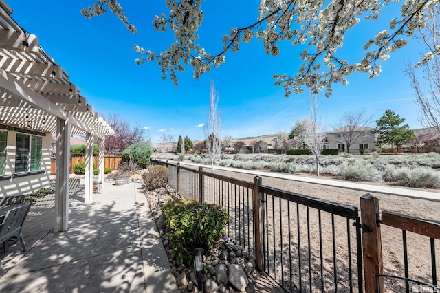 6650 Magical Dr, Sparks, NV 89436 - view of patio / terrace with a pergola, a fenced backyard, and a residential view
