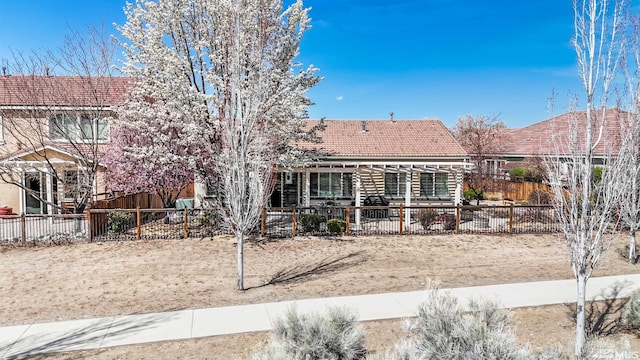 6650 Magical Dr, Sparks, NV 89436 - view of front of house featuring a tile roof and fence