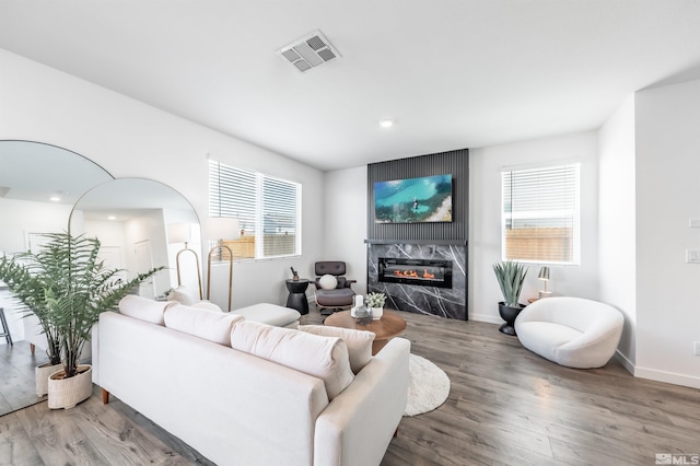 8855 Wolf Moon Dr, Reno, NV 89506 - living room with a premium fireplace, wood finished floors, healthy amount of natural light, baseboards, and recessed lighting