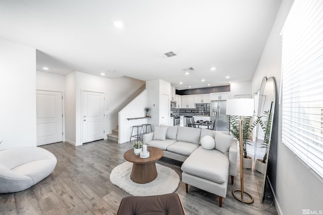 8855 Wolf Moon Dr, Reno, NV 89506 - living area featuring light wood-type flooring, stairs, recessed lighting, and plenty of natural light
