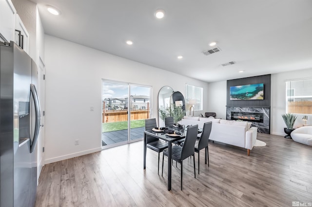 8855 Wolf Moon Dr, Reno, NV 89506 - dining room with wood finished floors, a premium fireplace, recessed lighting, and baseboards