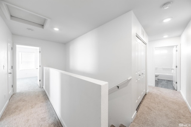8855 Wolf Moon Dr, Reno, NV 89506 - hallway featuring light carpet, attic access, an upstairs landing, recessed lighting, and baseboards