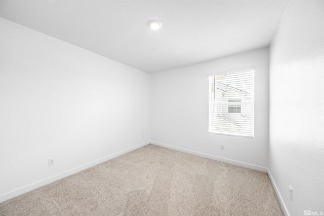 8855 Wolf Moon Dr, Reno, NV 89506 - spare room featuring light carpet and baseboards