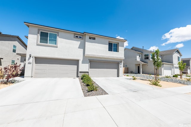 8855 Wolf Moon Dr, Reno, NV 89506 - view of front of home featuring an attached garage, concrete driveway, stucco siding, and a residential view