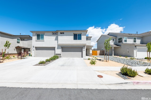 8855 Wolf Moon Dr, Reno, NV 89506 - view of front of property featuring stucco siding, a garage, driveway, and fence