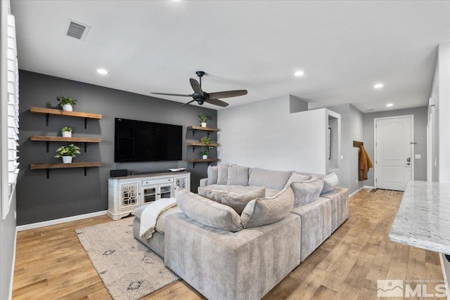 living area with ceiling fan, recessed lighting, baseboards, and light wood finished floors