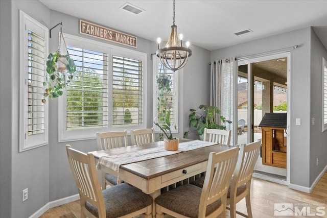 dining space with light wood-style floors, baseboards, and healthy amount of natural light