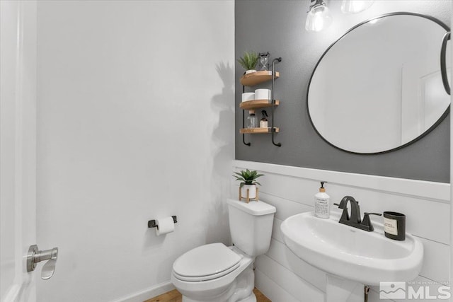 half bathroom with toilet and a sink