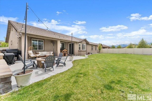 rear view of house with an outdoor hangout area, a patio area, stucco siding, and roof with shingles