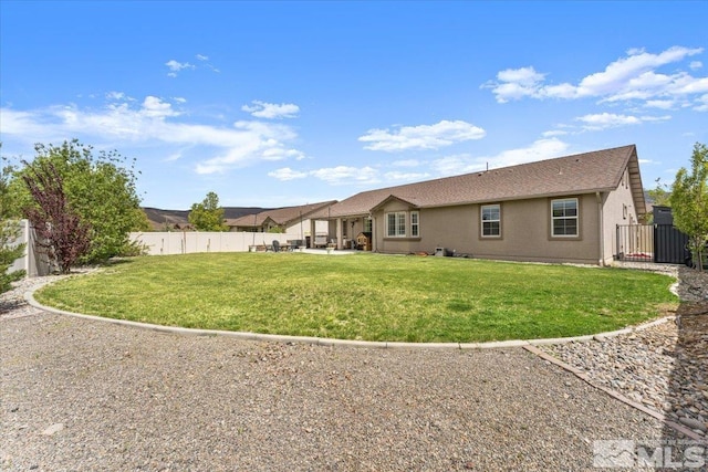 back of house with a patio area, a gate, and roof with shingles