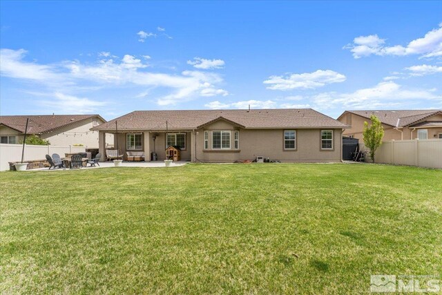 rear view of property with a patio area and stucco siding