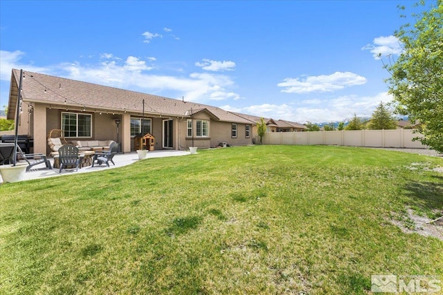rear view of property featuring a patio area, stucco siding, and an outdoor hangout area