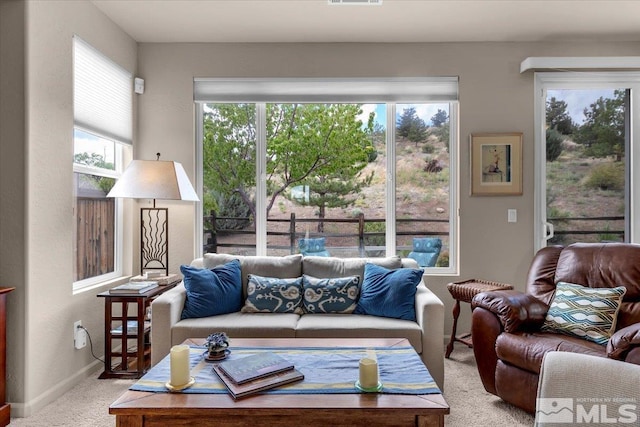 living room featuring carpet flooring and baseboards