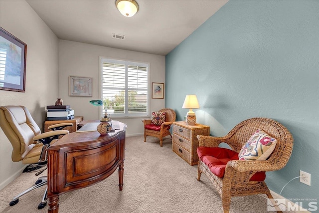 office space featuring light carpet and baseboards