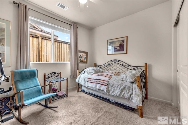 bedroom with carpet, baseboards, a ceiling fan, and a closet