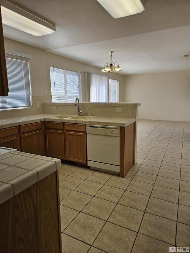 9995 Brightridge, Reno, NV 89506 - kitchen with dishwasher, a sink, light tile patterned floors, a chandelier, and tile countertops