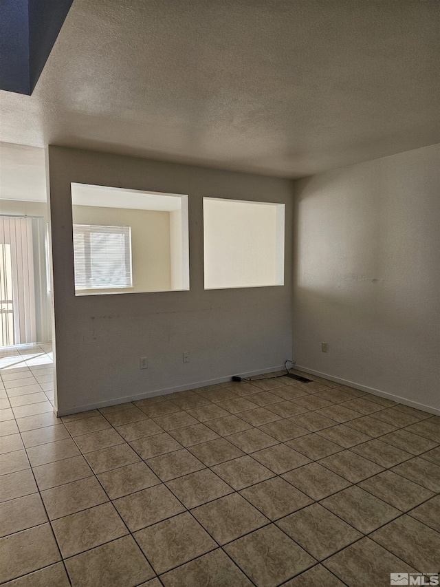 9995 Brightridge, Reno, NV 89506 - tiled empty room with a textured ceiling and baseboards