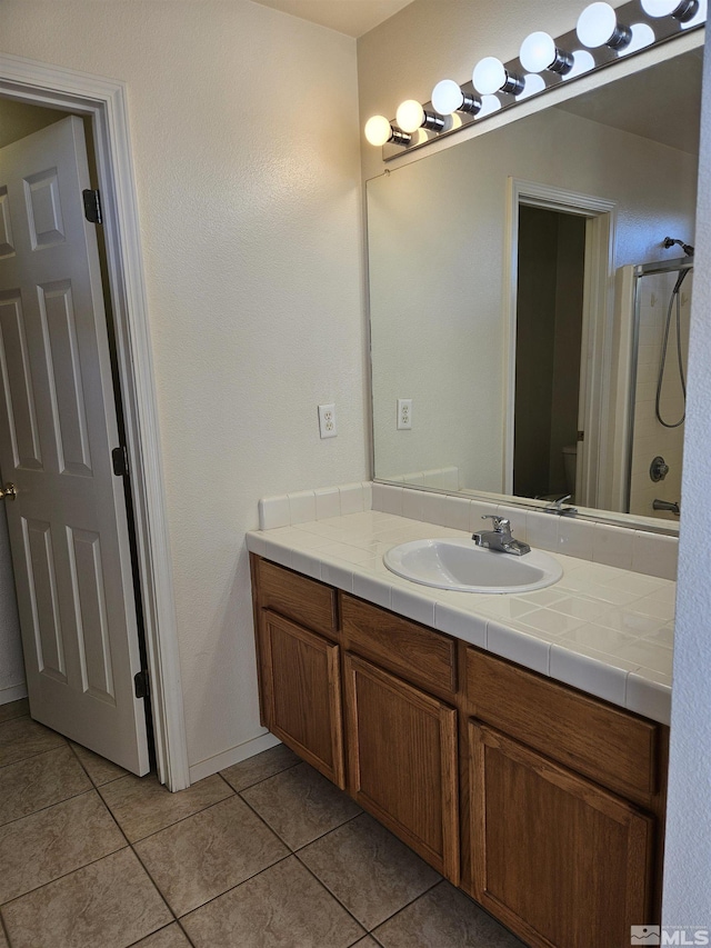 9995 Brightridge, Reno, NV 89506 - full bathroom with tile patterned floors, vanity, a shower, and toilet