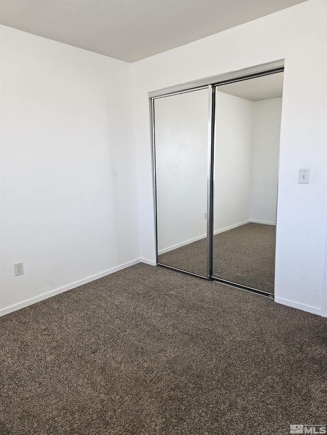 9995 Brightridge, Reno, NV 89506 - unfurnished bedroom with baseboards, a closet, and dark colored carpet