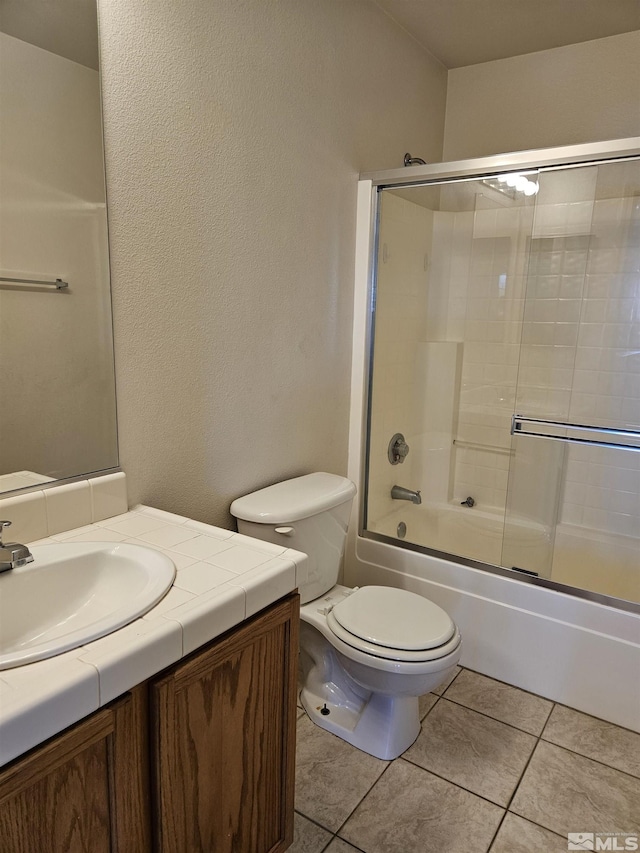 9995 Brightridge, Reno, NV 89506 - full bathroom featuring toilet, vanity, bath / shower combo with glass door, and tile patterned floors