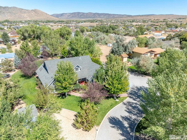 aerial view of property and surrounding area featuring mountains