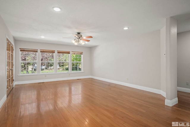 unfurnished living room featuring ceiling fan, baseboards, light wood-style flooring, and recessed lighting