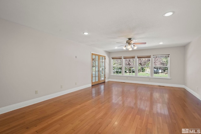 spare room featuring ceiling fan, baseboards, recessed lighting, and light wood-style floors