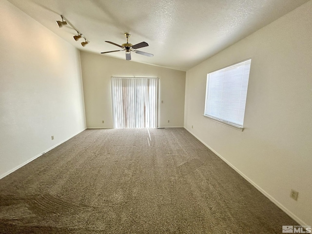 1447 N Marion Russell, Gardnerville, NV 89410 - spare room featuring lofted ceiling, ceiling fan, carpet, a textured ceiling, and baseboards