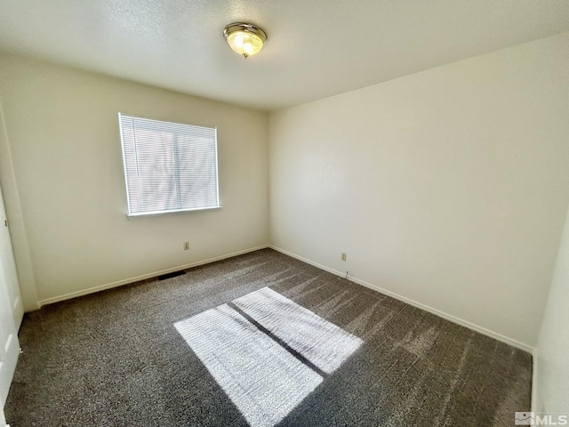 1447 N Marion Russell, Gardnerville, NV 89410 - spare room with dark carpet and baseboards