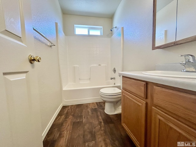1447 N Marion Russell, Gardnerville, NV 89410 - bathroom with toilet, wood finished floors, vanity,  shower combination, and a textured wall