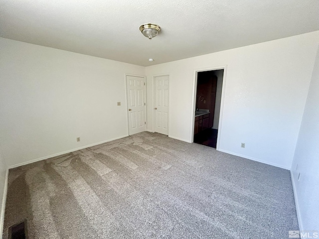 1447 N Marion Russell, Gardnerville, NV 89410 - unfurnished bedroom with carpet floors, baseboards, and connected bathroom