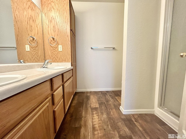 1447 N Marion Russell, Gardnerville, NV 89410 - full bath featuring wood finished floors, double vanity, baseboards, and a shower with door