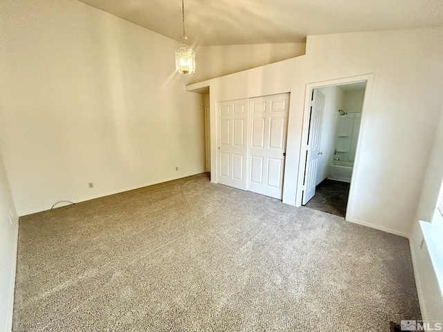 1449 N Marion Russell Dr, Gardnerville, NV 89410 - unfurnished bedroom featuring carpet flooring, lofted ceiling, a closet, and ensuite bath