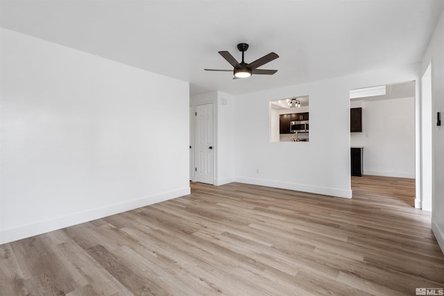 6798 Flower St, Reno, NV 89506 - unfurnished living room featuring ceiling fan, wood finished floors, and baseboards