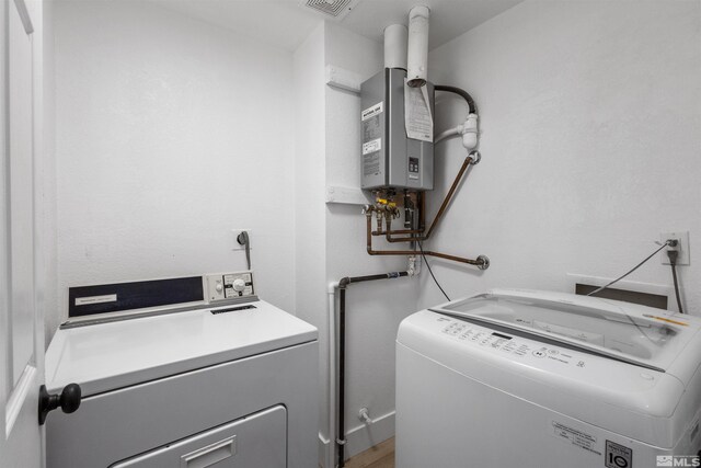 6798 Flower St, Reno, NV 89506 - washroom with washer and dryer and water heater