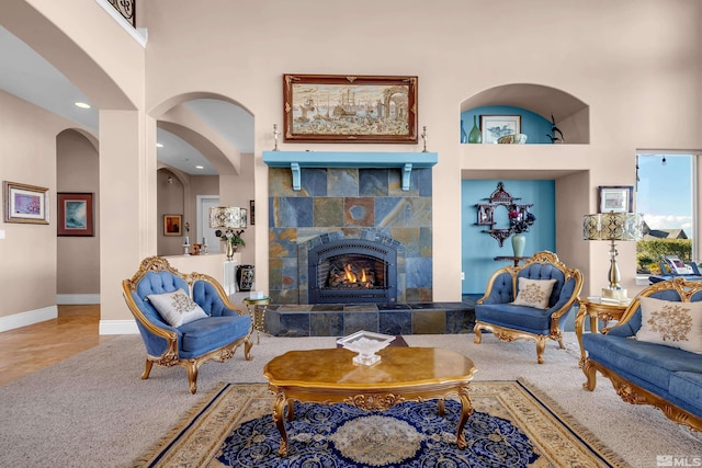 10401 Copper Cloud Dr, Reno, NV 89511 - carpeted living room with a fireplace, recessed lighting, baseboards, and arched walkways