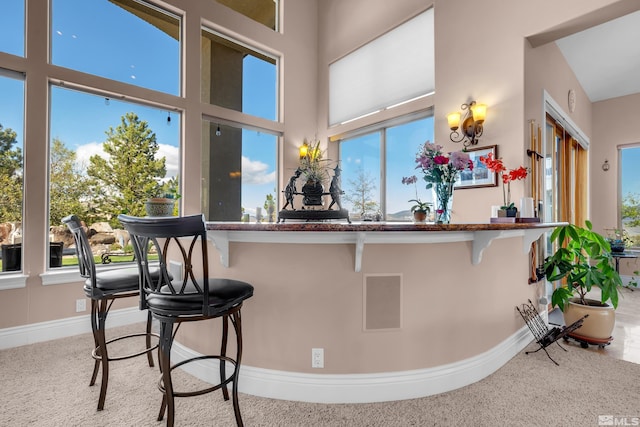10401 Copper Cloud Dr, Reno, NV 89511 - kitchen with a breakfast bar, carpet floors, and healthy amount of natural light