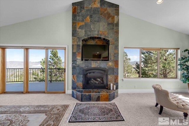 10401 Copper Cloud Dr, Reno, NV 89511 - carpeted living area featuring a fireplace, high vaulted ceiling, and baseboards