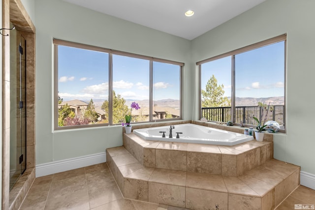 10401 Copper Cloud Dr, Reno, NV 89511 - bathroom featuring a garden tub, baseboards, and a mountain view