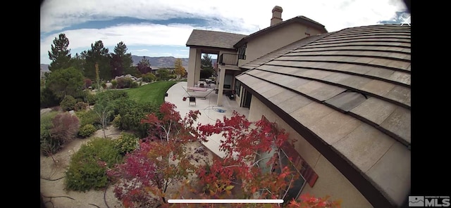 10401 Copper Cloud Dr, Reno, NV 89511 - view of side of property featuring a chimney and a mountain view